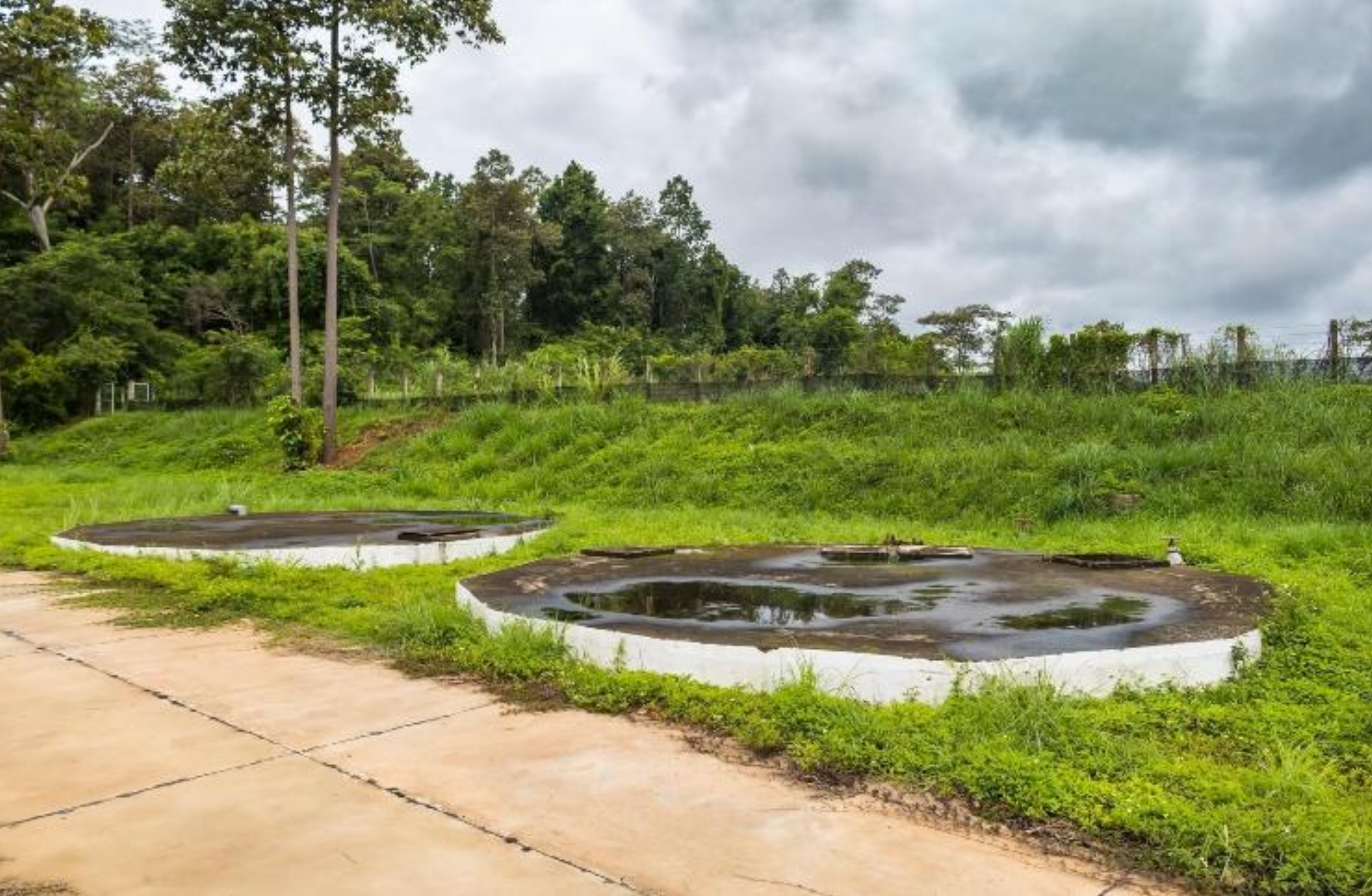 Completed underground water treatment tanks in a field