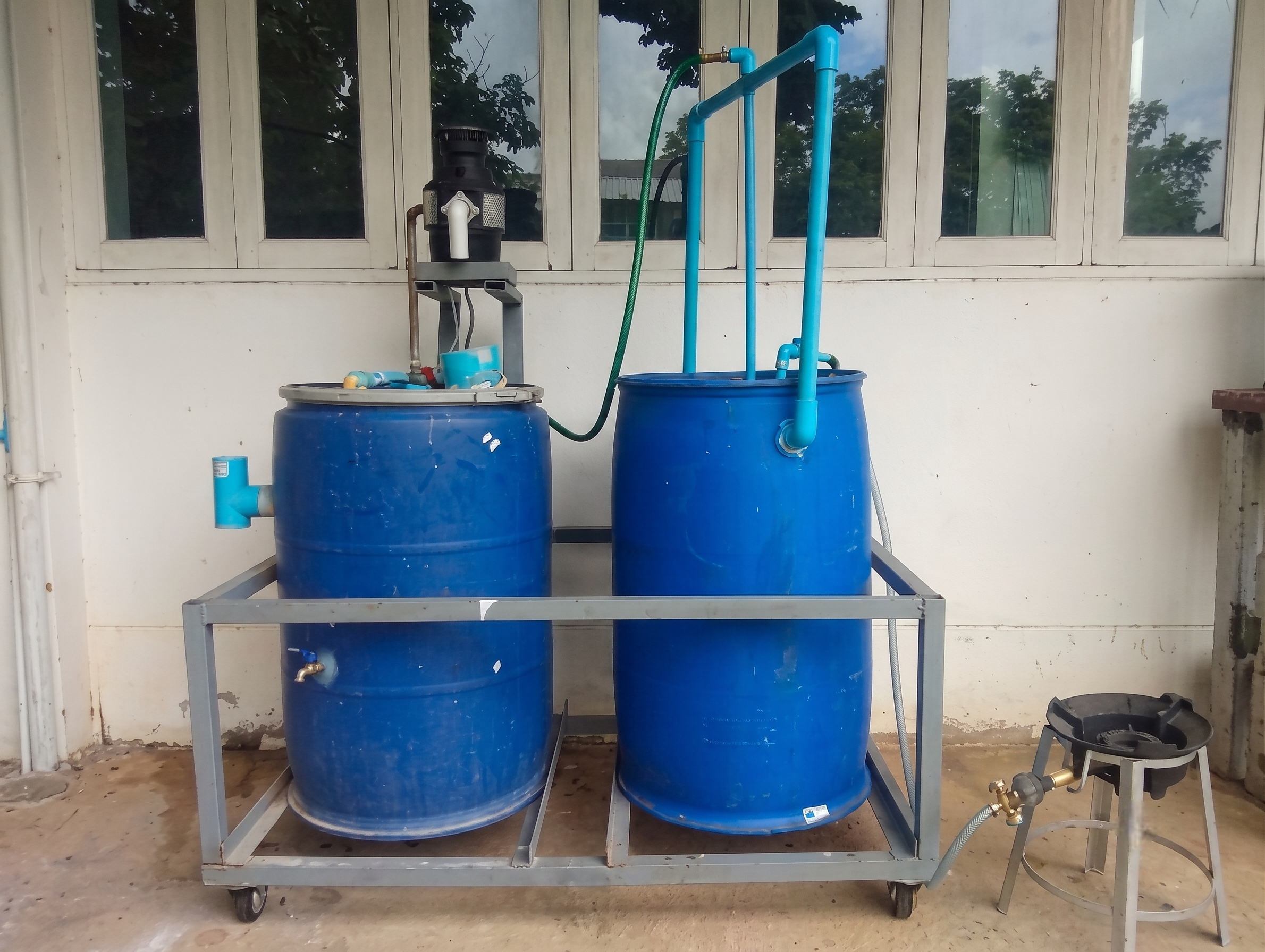 Biogas food waste system with blue barrels