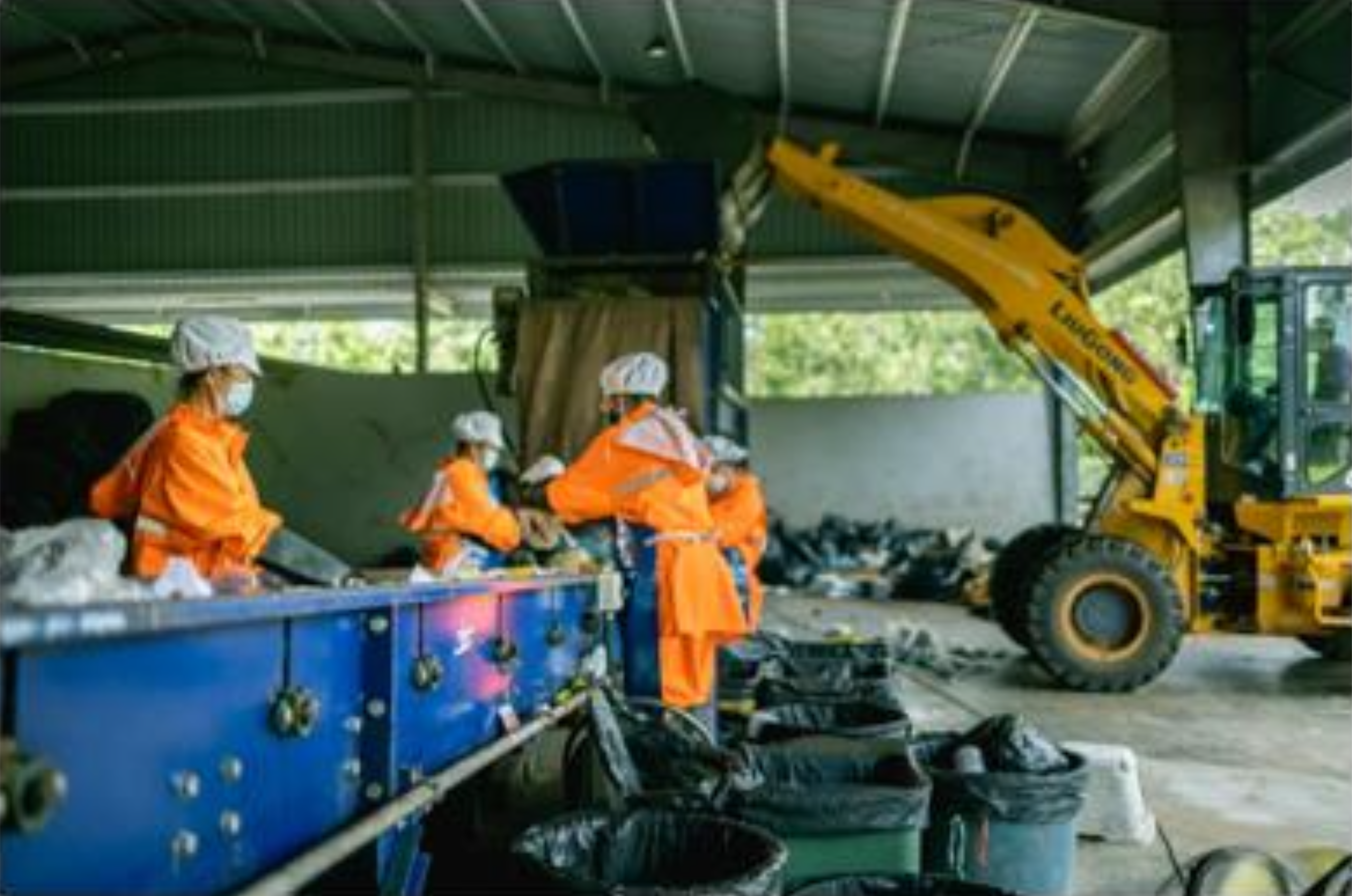 Workers at waste sorting conveyor