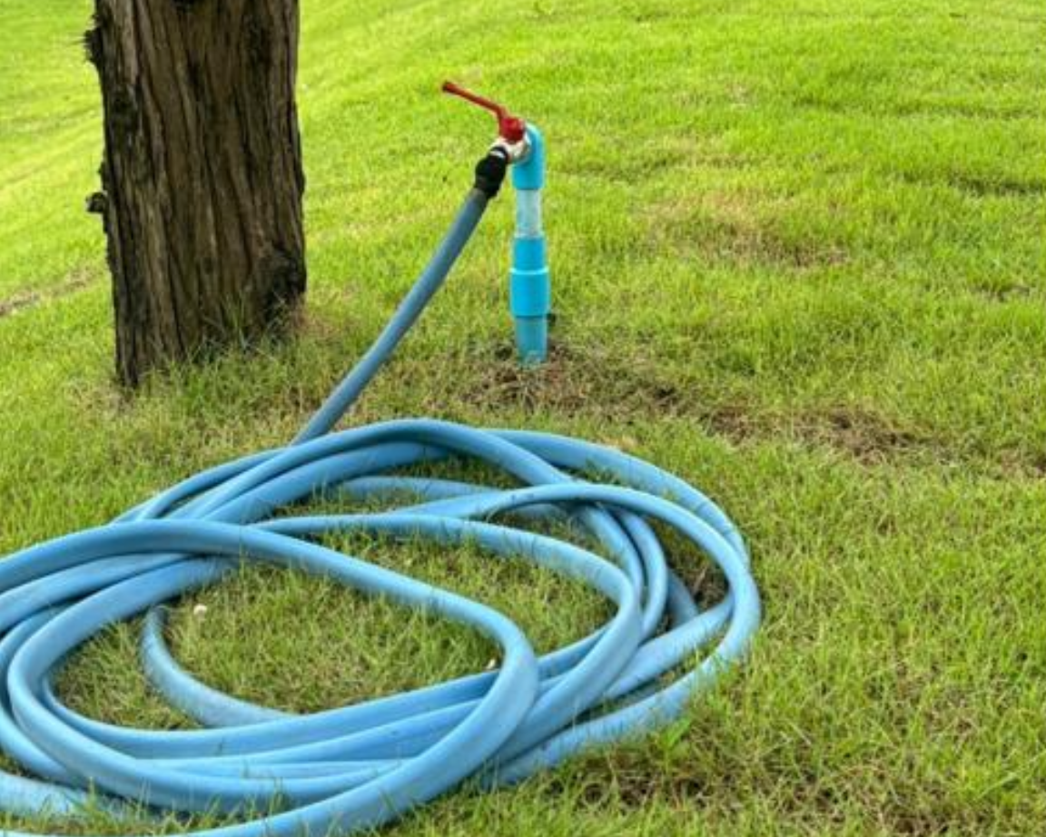 Hose reel connected to a treated water tap on the lawn