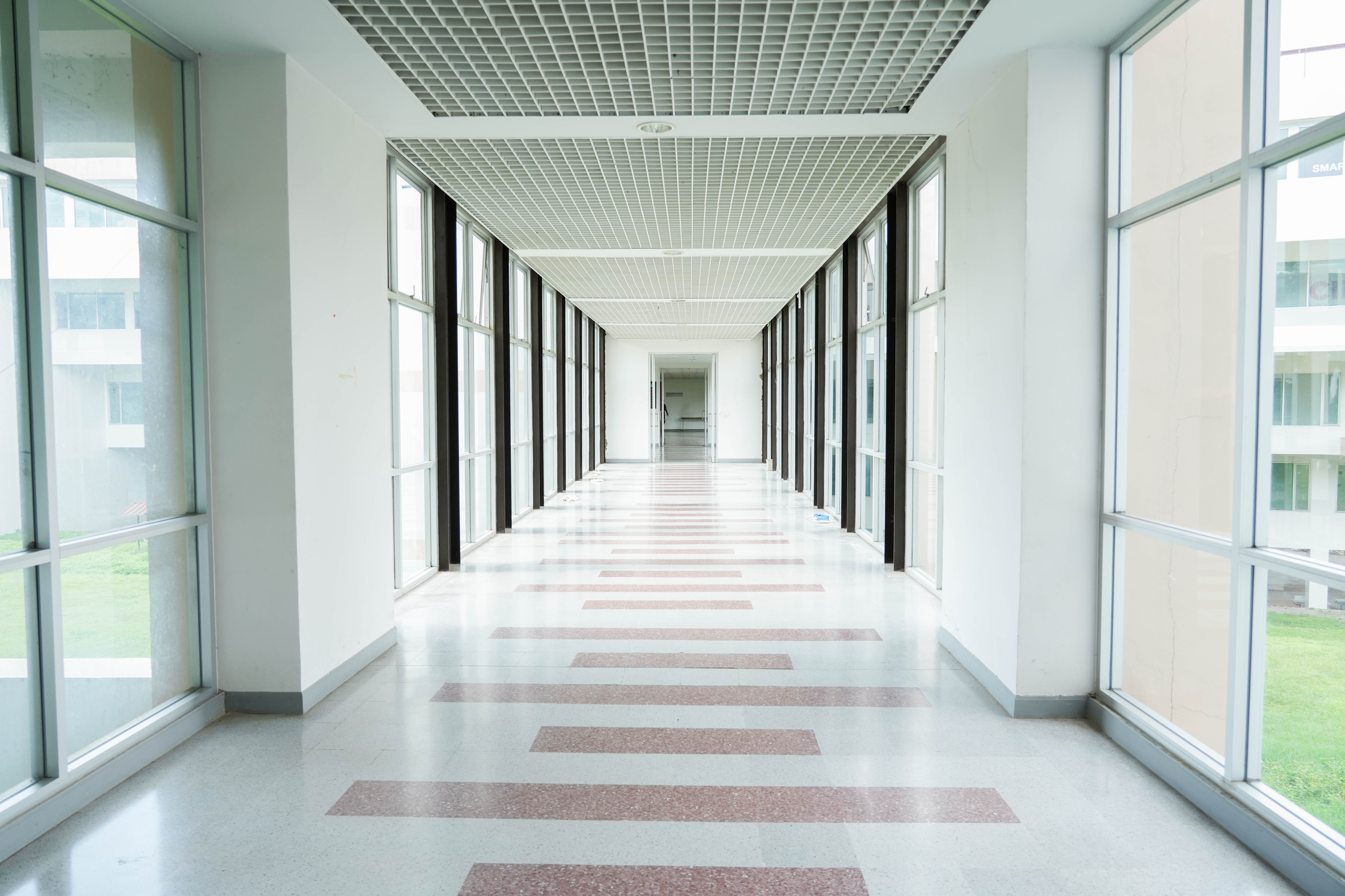 Naturally lit corridor with large windows, University of Phayao