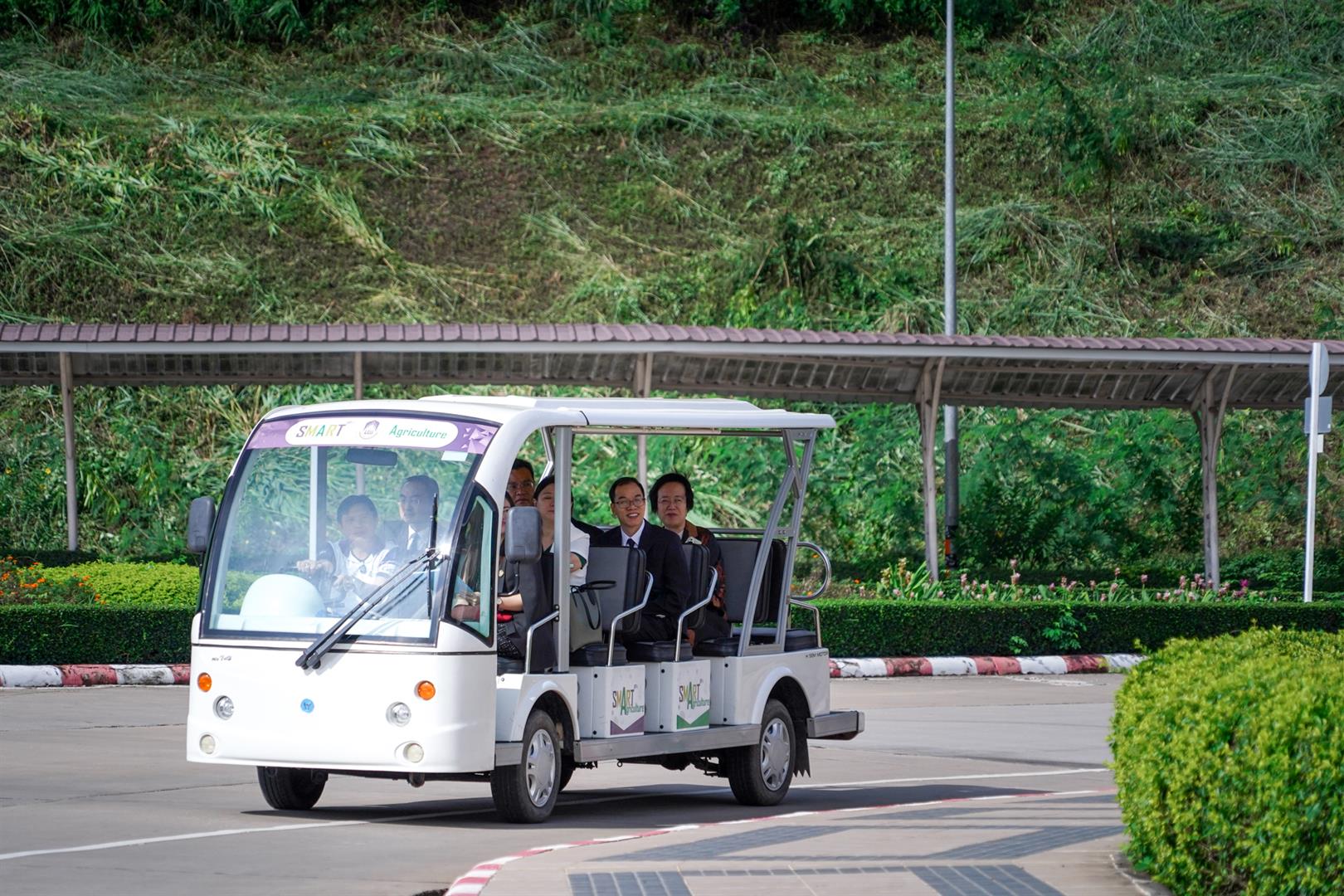 Electric golf cart on campus road