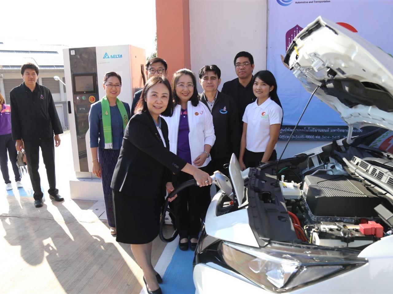 Staff inspecting electric car engine