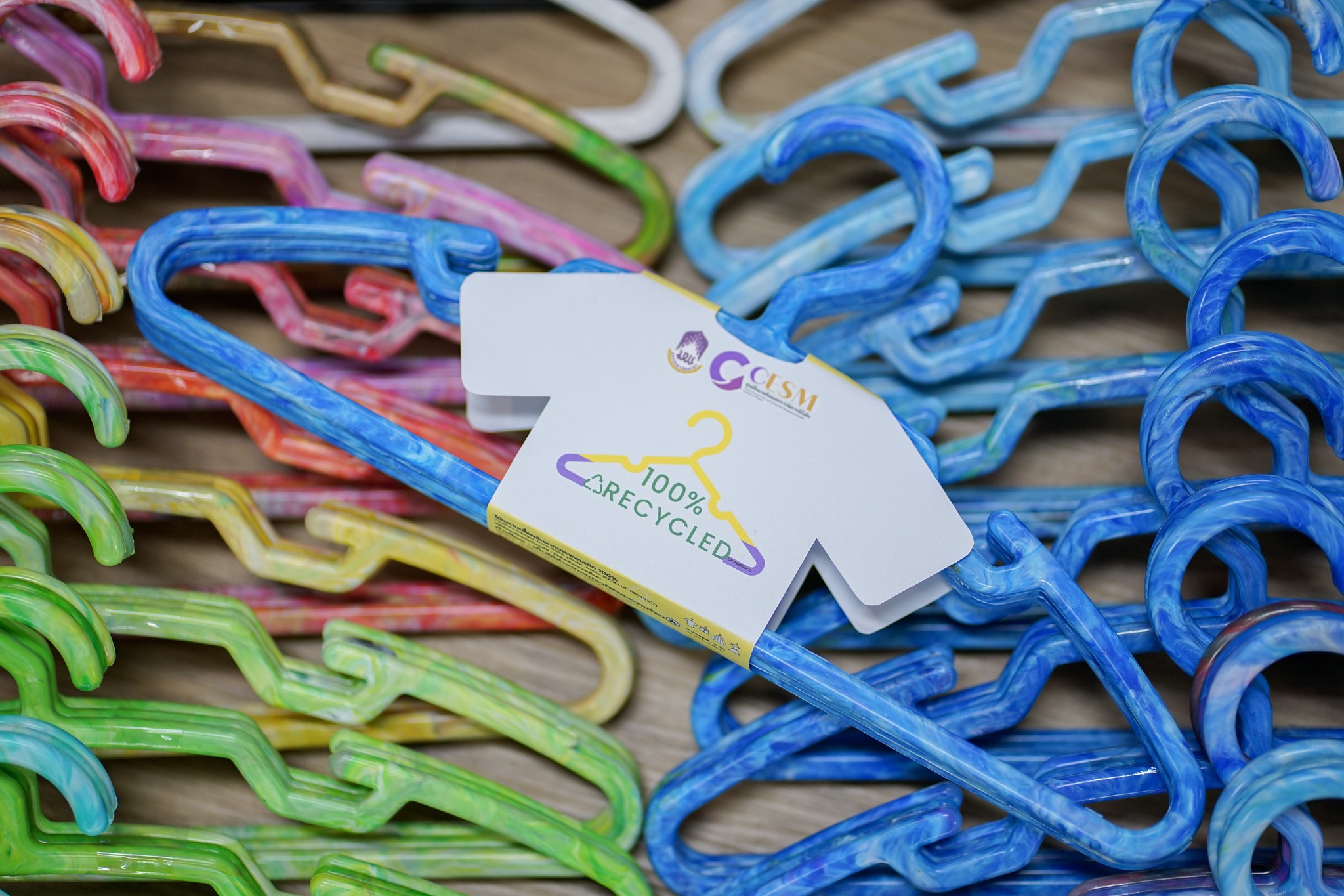 Recycled plastic clothes hangers in green blue and yellow colors