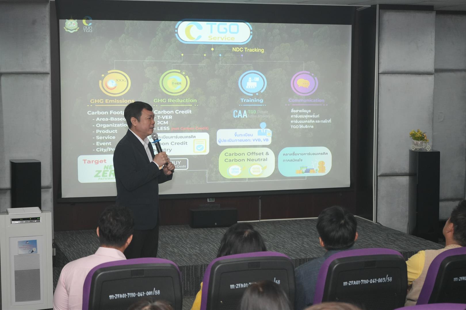 Speaker presenting carbon neutrality management topics to senior executives