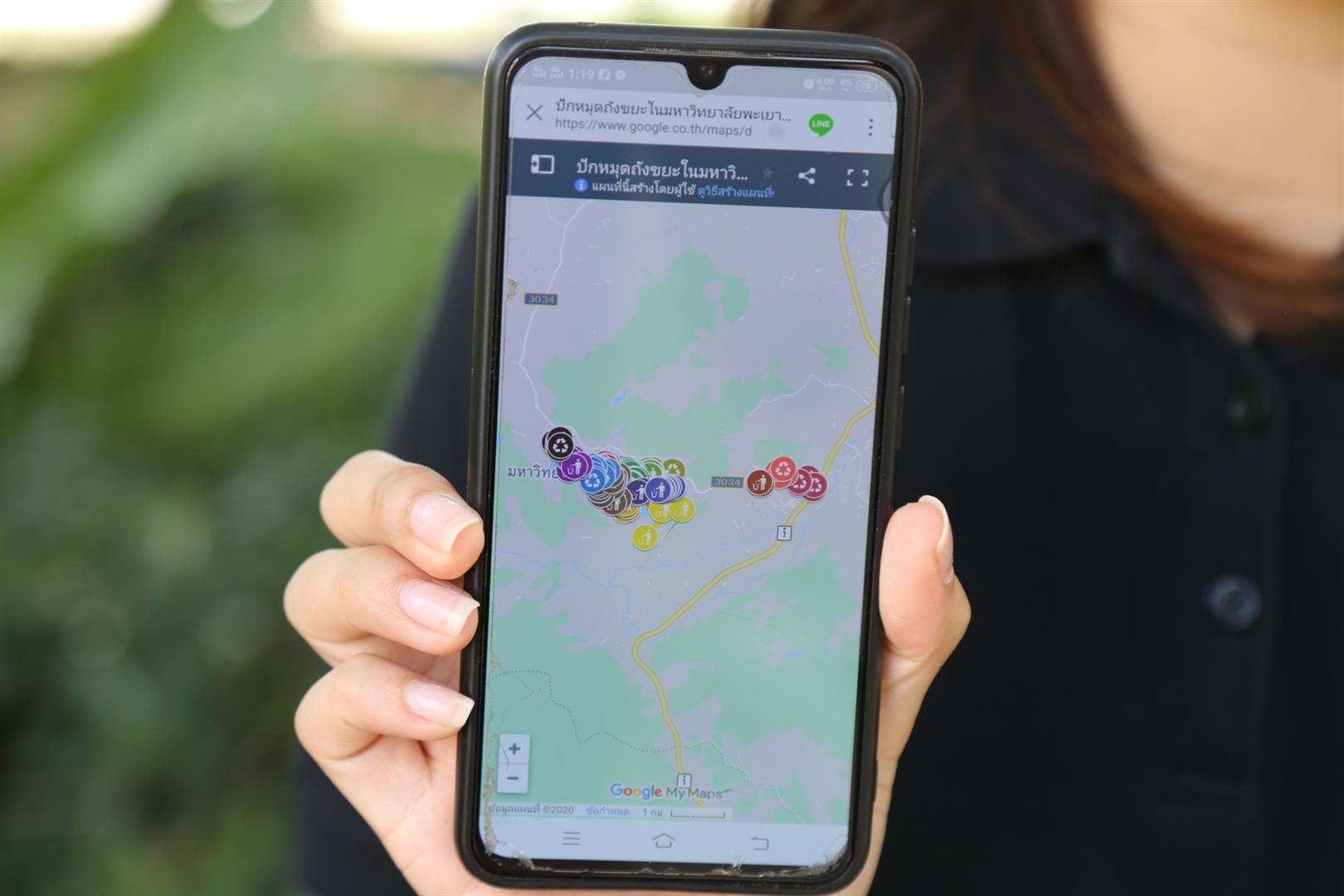 Mobile phone showing waste disposal map application, University of Phayao