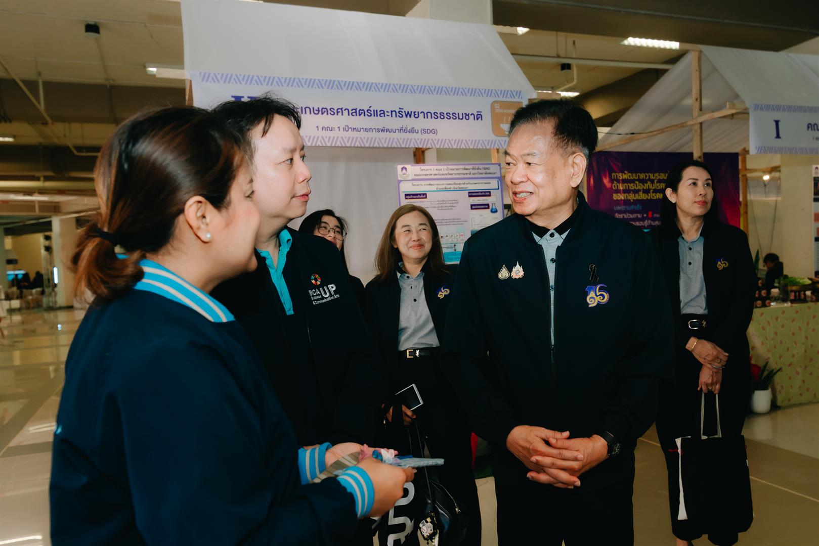 Exhibition booth showcasing area-based development research at the 15th Phayao Research Conference