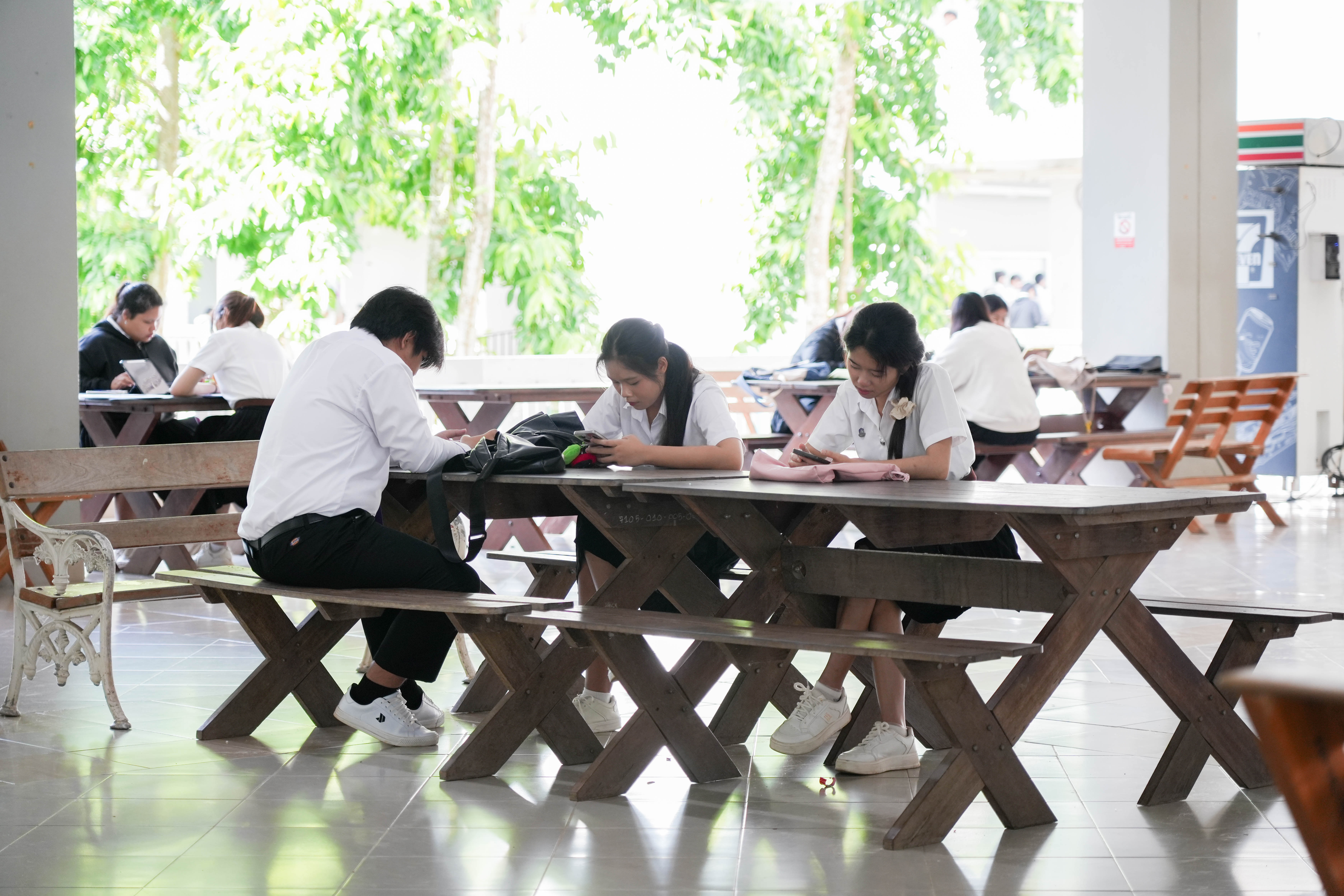 Students studying in a naturally ventilated open corridor, University of Phayao