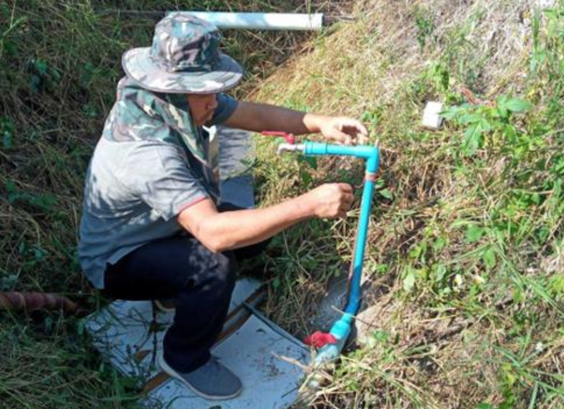 Staff member installing a treated water pump